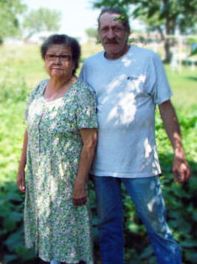 Paul and Jackie posing in front of their Project Grow garden