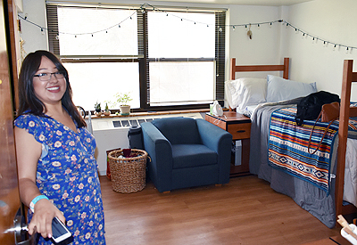 Photo of Kayleigh showing us the inside of her dorm room,