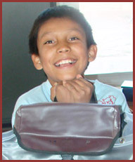 Native American student happy with his school supplies and backpack