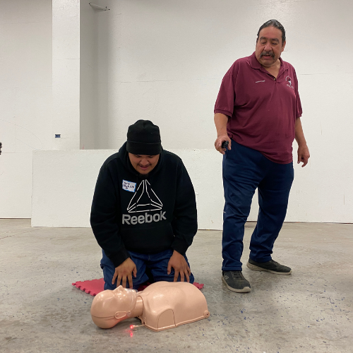 Harold instructs Syrus how to get air back into the lungs of an unresponsive victim