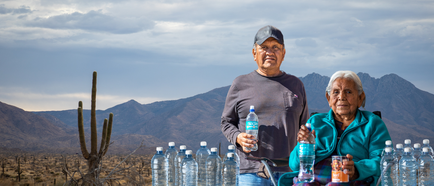 Photo of two elders holding water bottles
